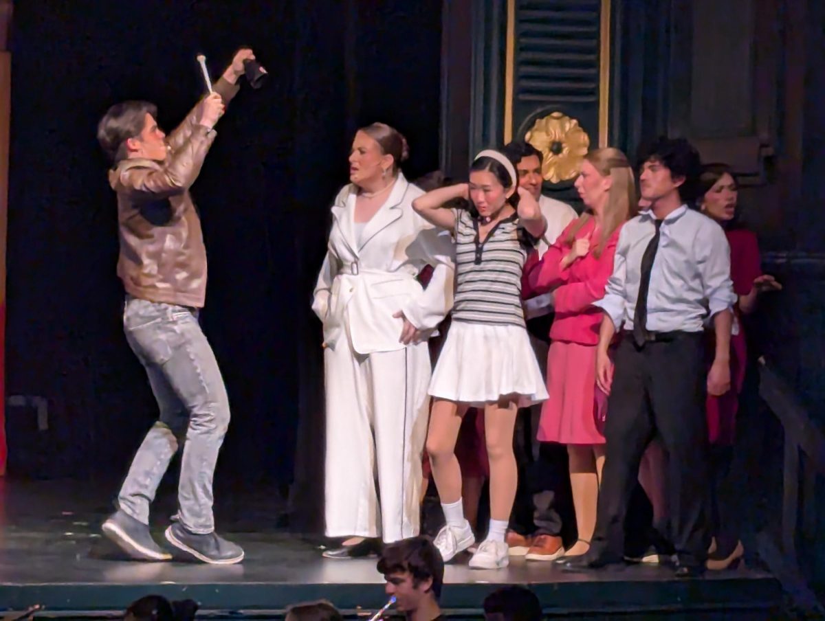 Trent Oliver, played by Logan Jew-Fortner ('27), helps crash a PTA meeting with his trusty cowbell.