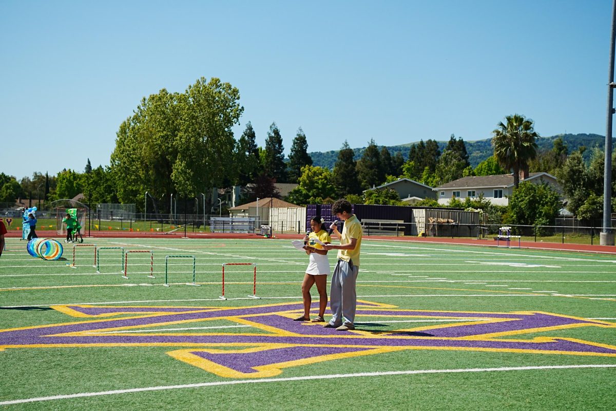 Bright and early on April 17, Allison Medios ('26) and Nathaniel Kelly ('26) rehearse their script ahead of the Survivor rally, preparing to energize the crowd as MCs. The Survivor rally is an annual tradition at Amador, where representatives from each graduating class participate in a number of games and obstacle courses, earning points for their classmates.