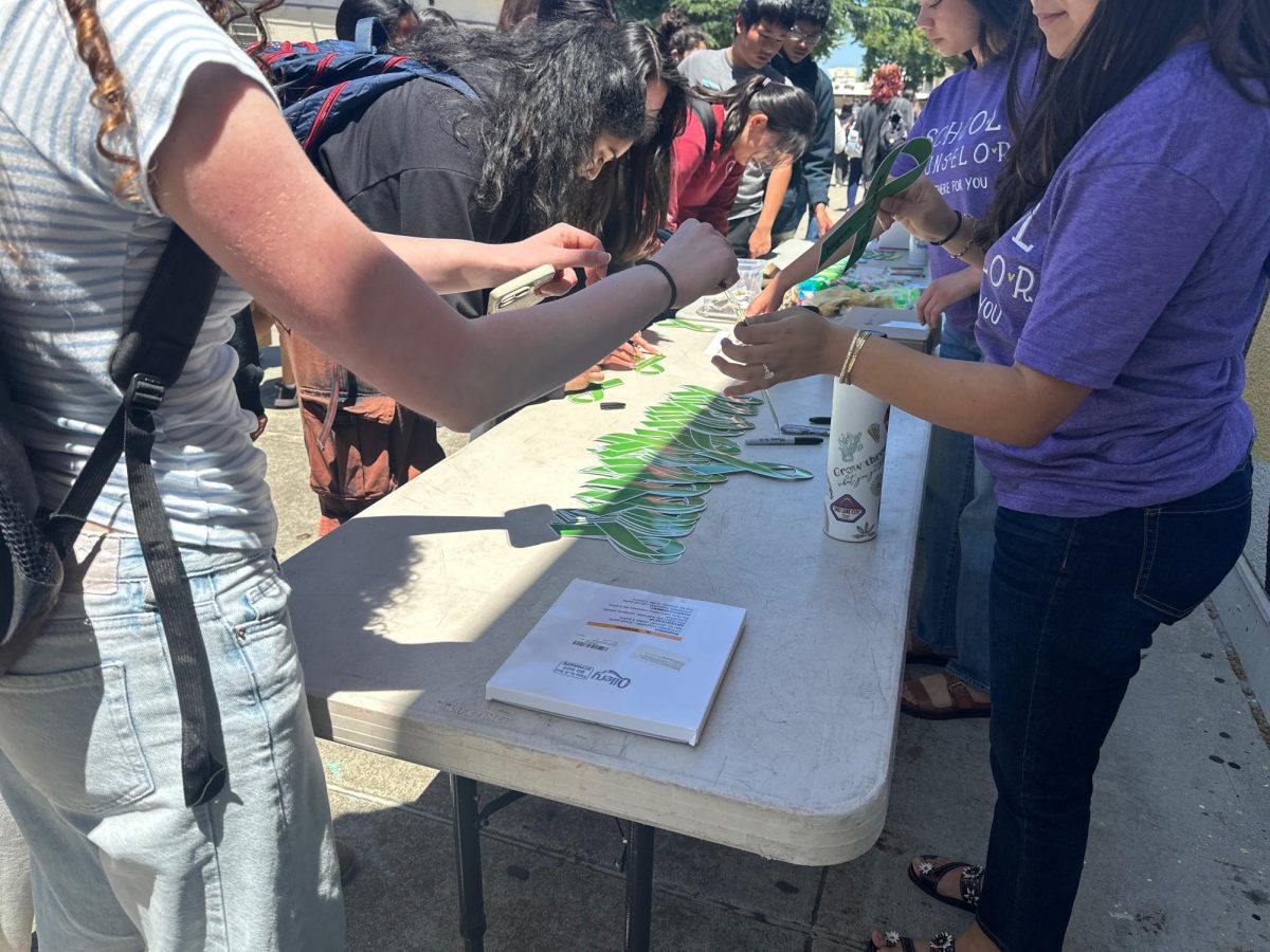 Pledge Friday had green ribbons, a symbol for Mental Health awareness and advocacy, for students to write their names and pledge to take care of their mental health.